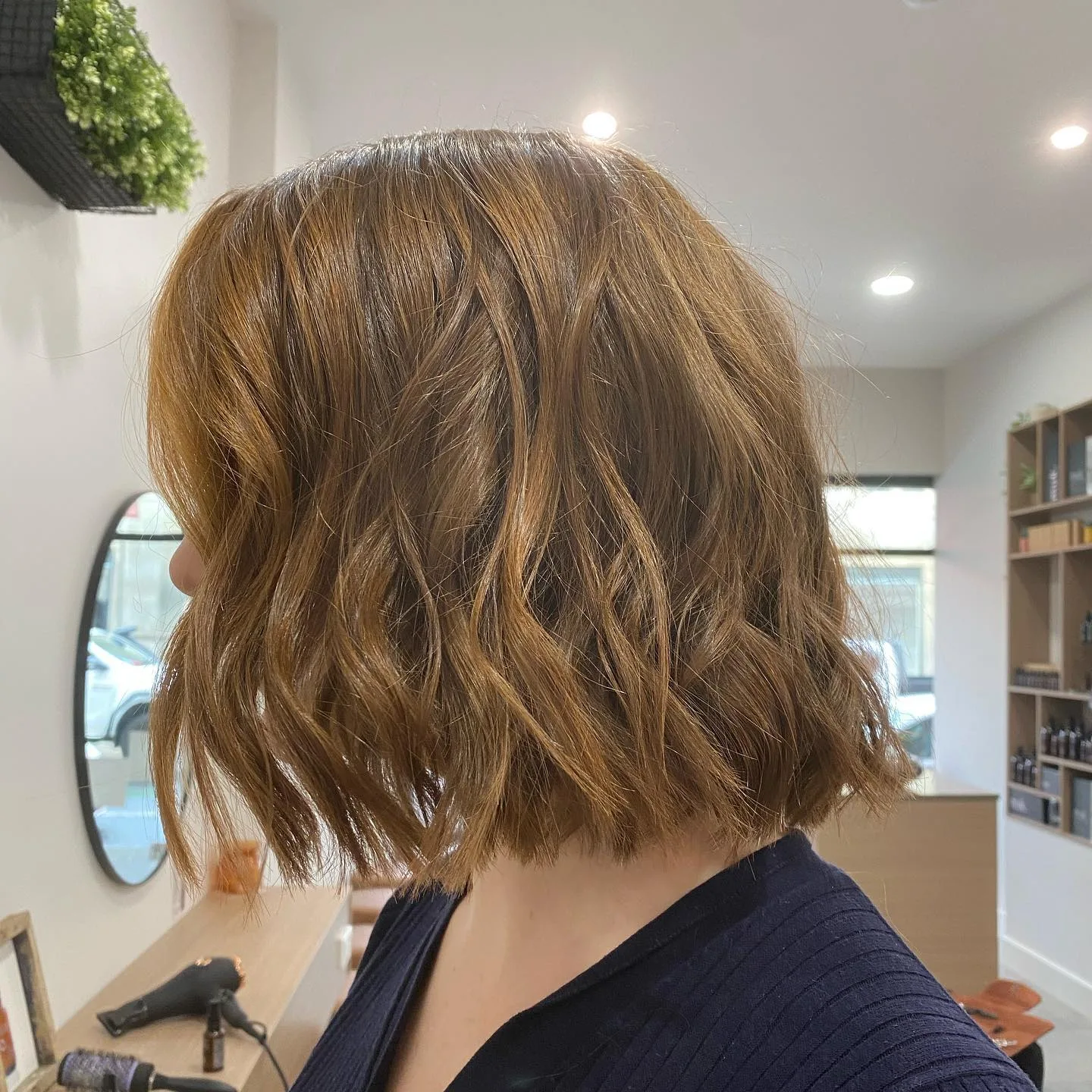 Copper-brown textured bob, salon behind
