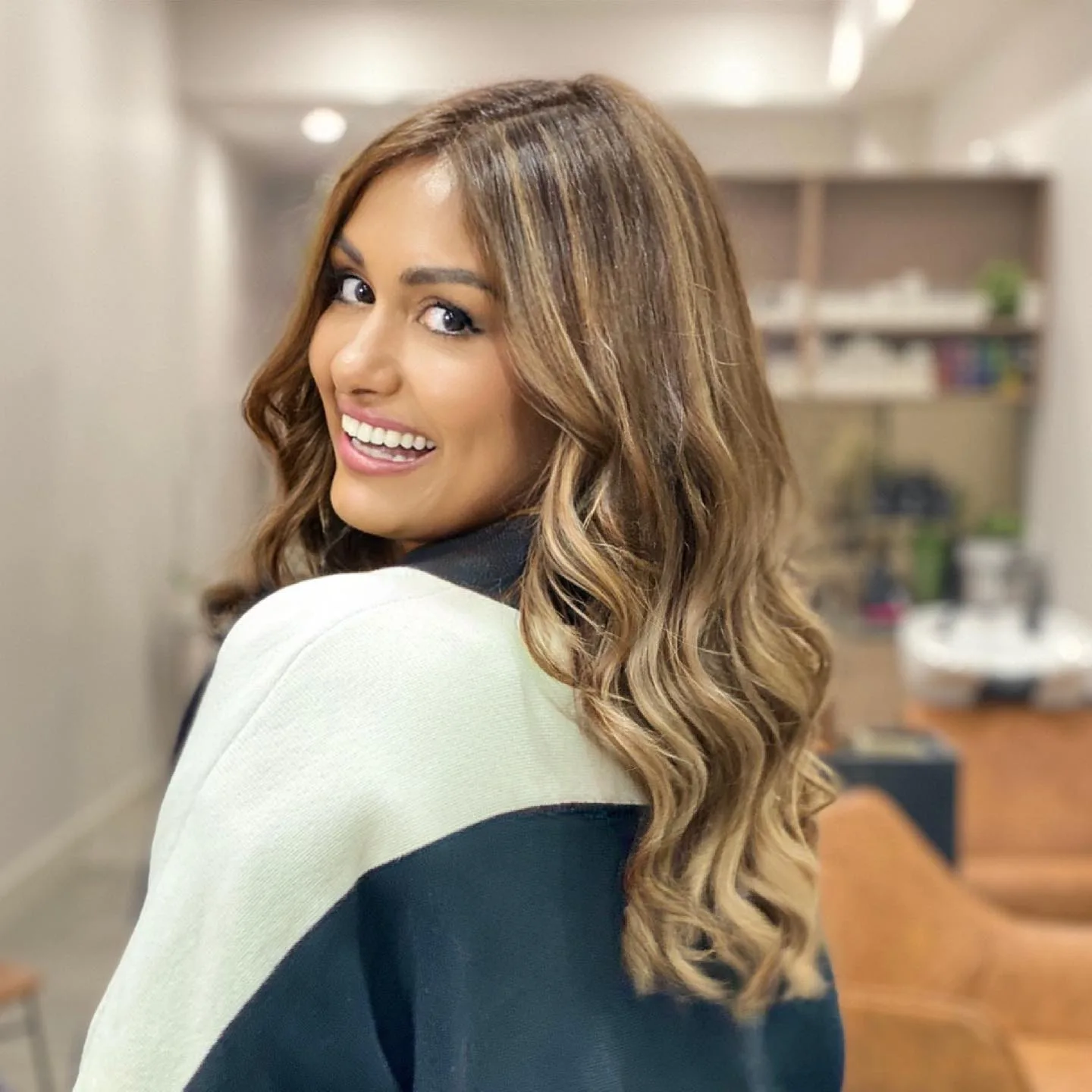 Honey balayage waves over the shoulder